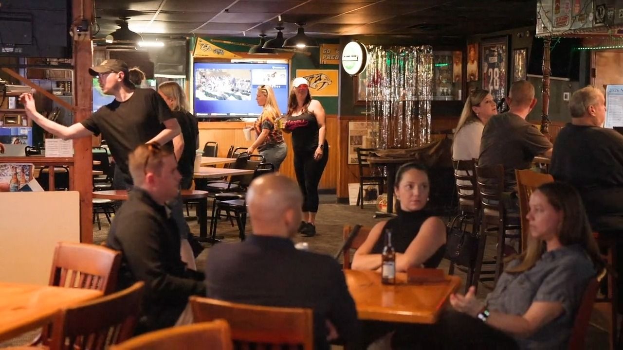 A full room at Bar South with the TVs on