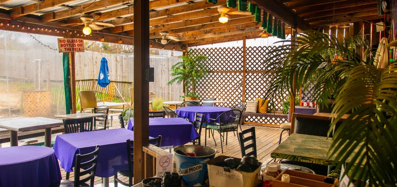 The covered patio at Bar South, lattice and plants along the rail