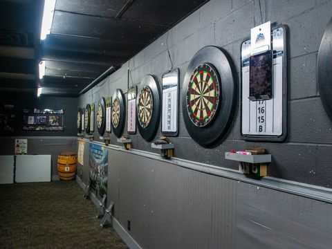 Wall of steel-tip dart boards at Bar South