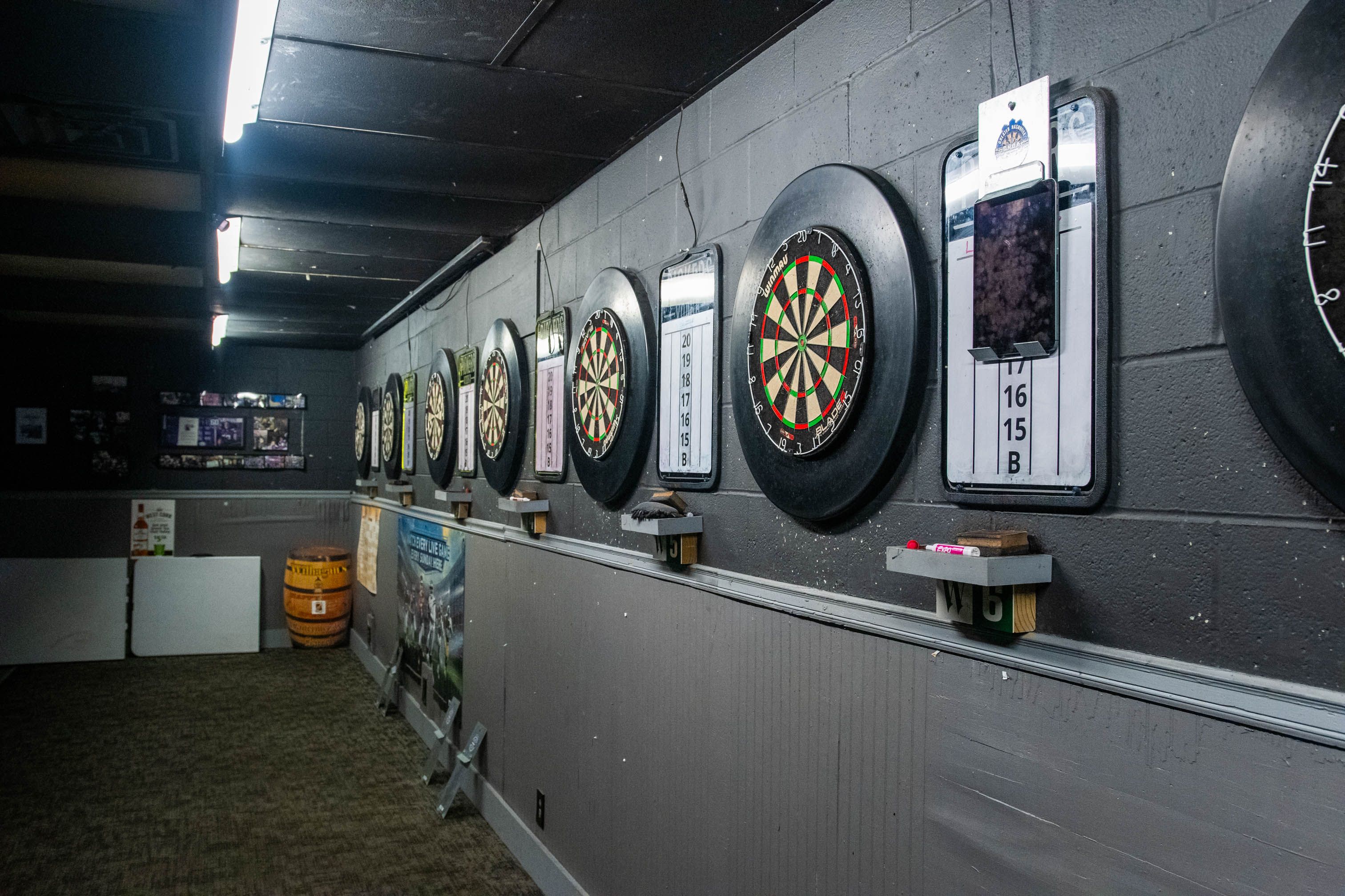 The wall of steel-tip dart boards in the darts room at Bar South